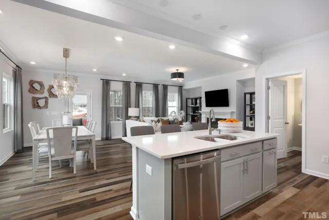 a kitchen with a sink cabinets and wooden floor