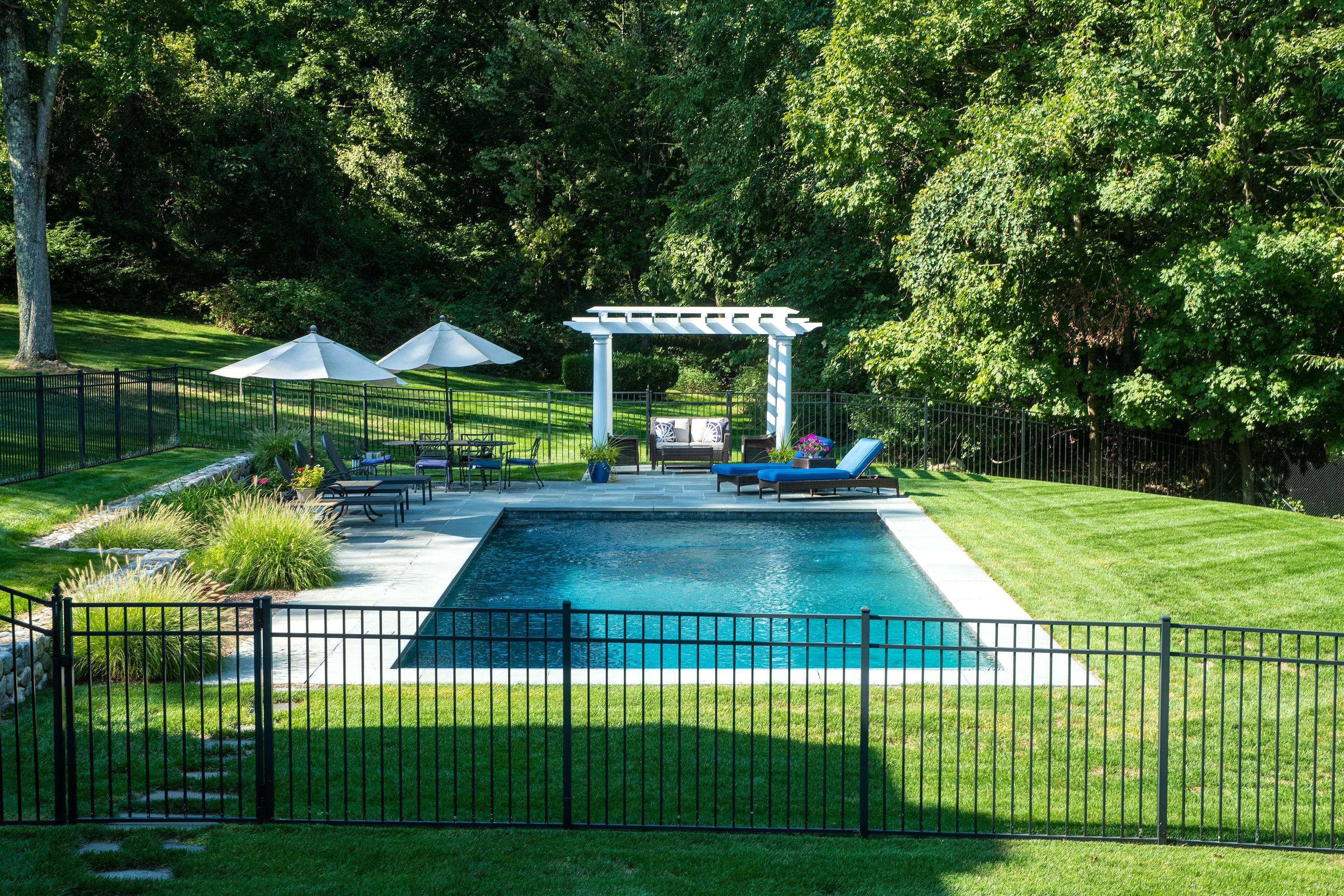 1381 Smith Ridge Road New Canaan, CT 06840 - Photo 2 of 35 a view of a swimming pool and deck in the garden