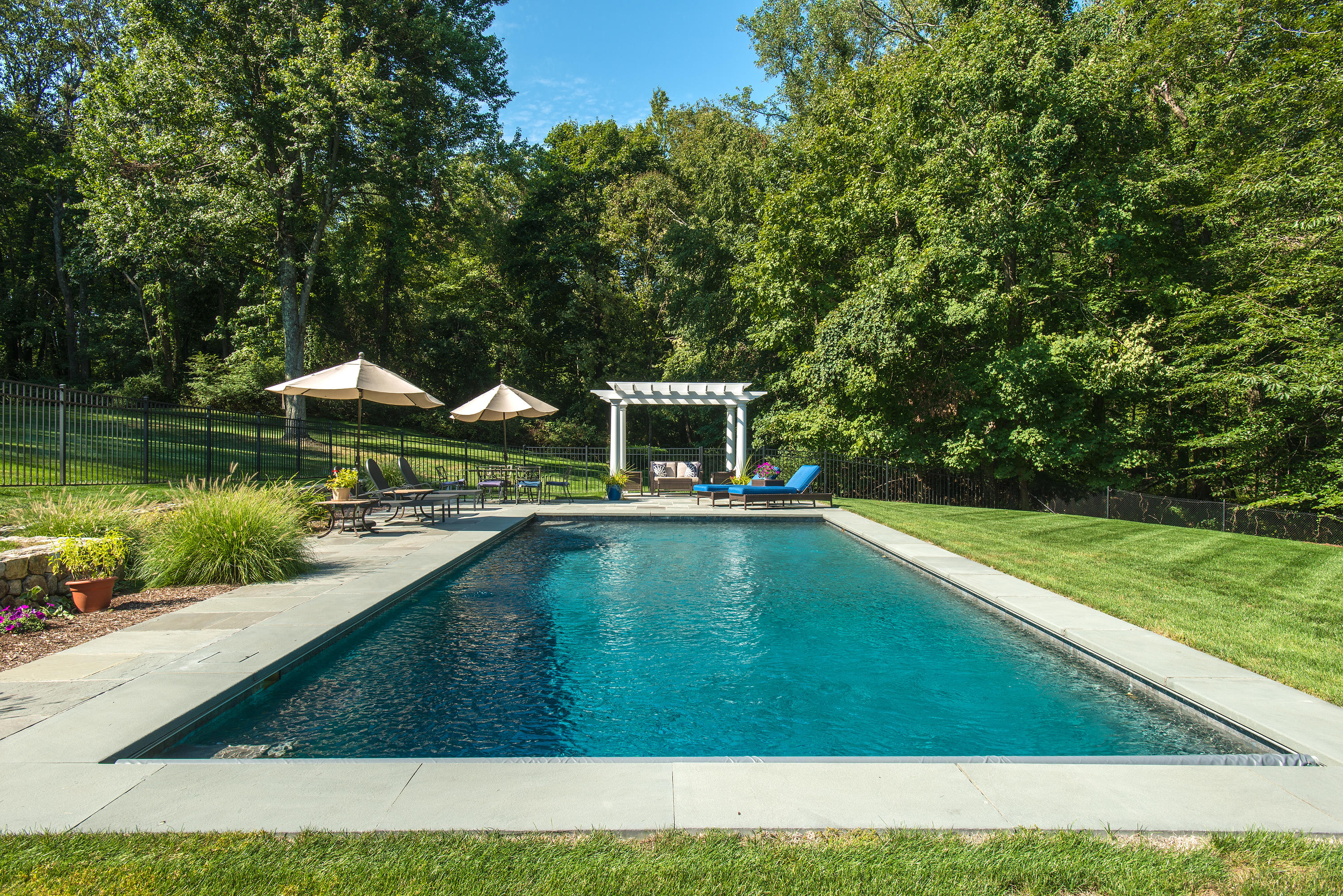 1381 Smith Ridge Road New Canaan, CT 06840 - Photo 30 of 35 a view of a swimming pool with a yard