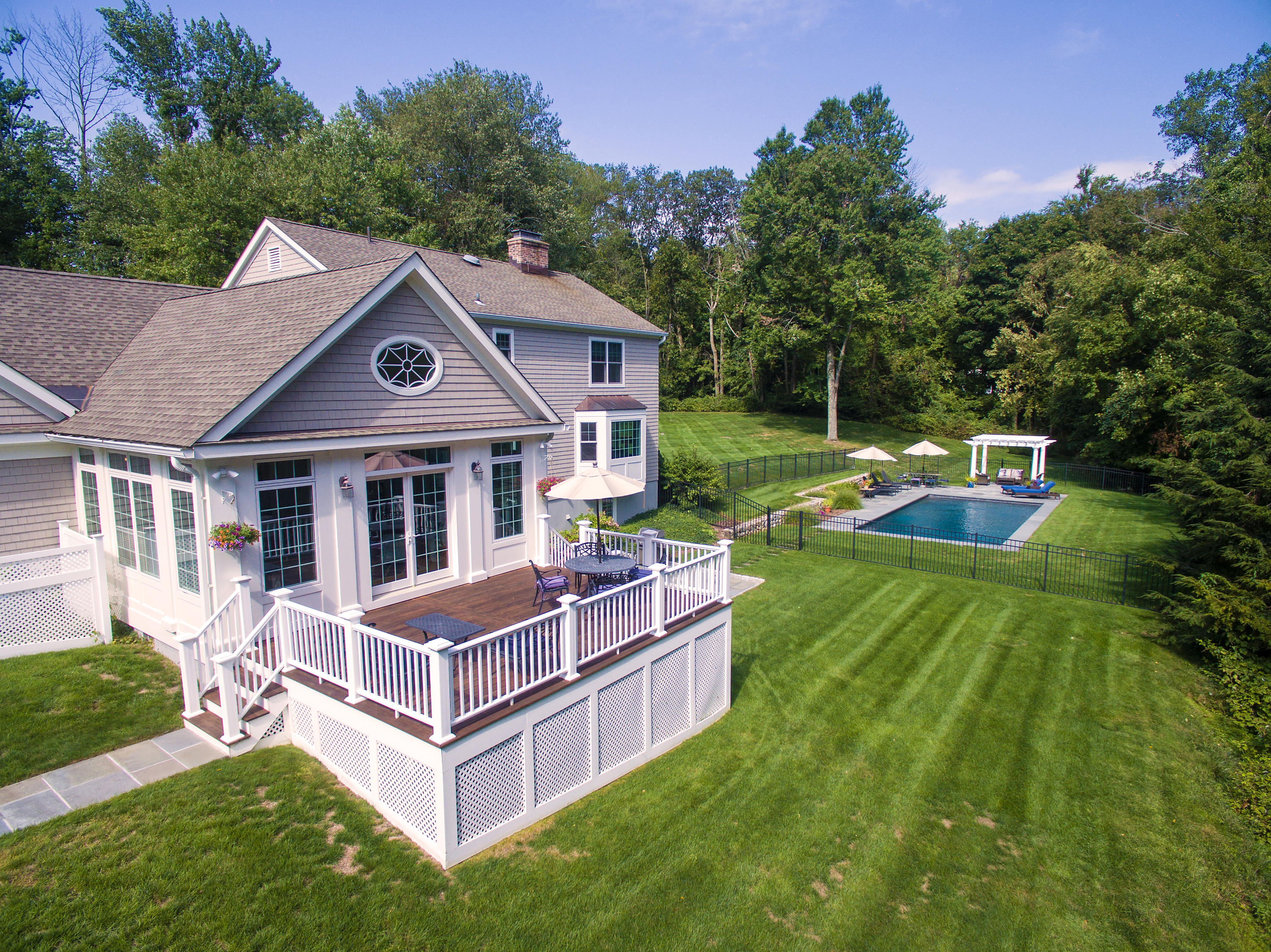 1381 Smith Ridge Road New Canaan, CT 06840 - Photo 4 of 35 a front view of a house with a yard table and chairs