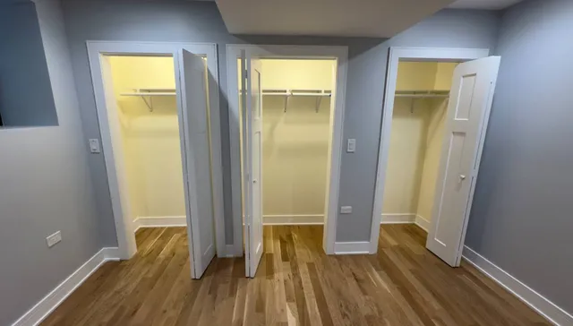 a view of walk in closet with wooden floor