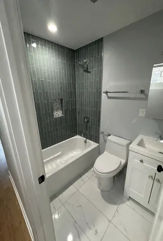 a bathroom with a toilet a sink and a bathtub