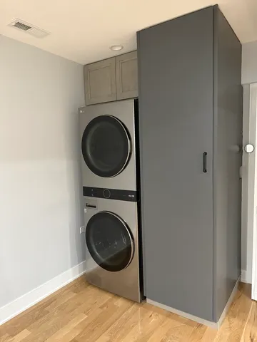 a view of a bedroom with washer and dryer
