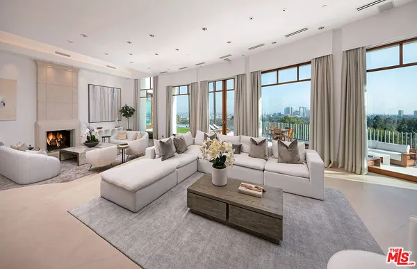 a living room with furniture and large windows