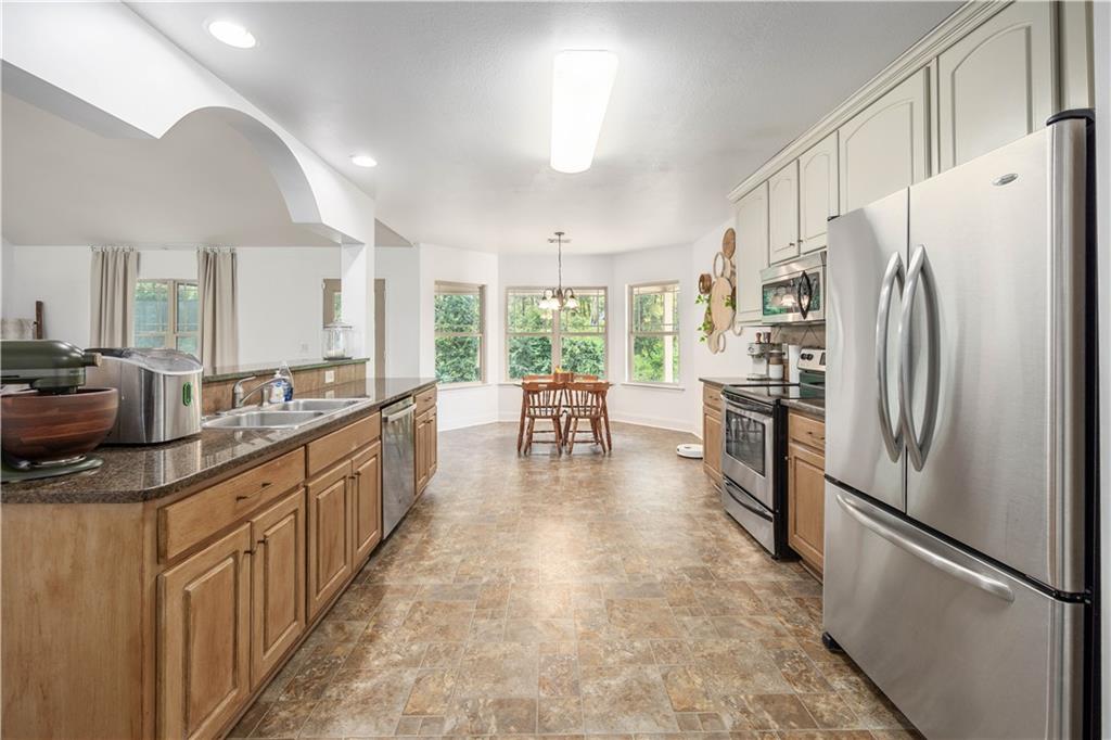 19 Isbell Road Fort Mitchell, AL 36856 - Photo 13 of 37 Spacious kitchen with wood-finish flooring, stainless steel appliances, and ample cabinetry