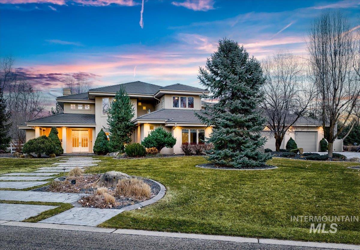 1400 North Razza Way Eagle, ID 83616 - Photo 1 of 50 View of front facade featuring stucco siding, a lawn, and a chimney