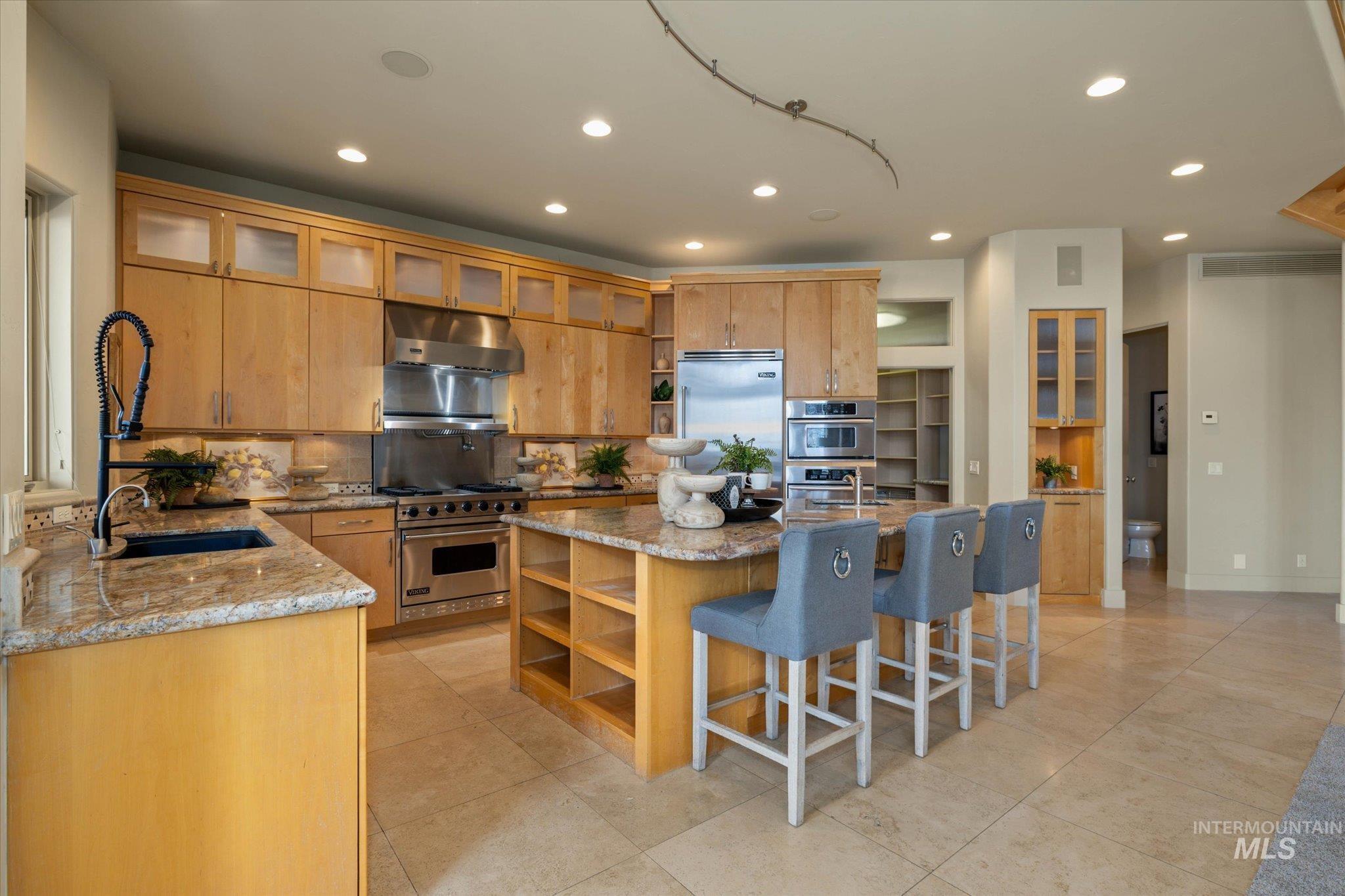 1400 North Razza Way Eagle, ID 83616 - Photo 15 of 50 Kitchen featuring open shelves, recessed lighting, light stone countertops, backsplash, and high end appliances