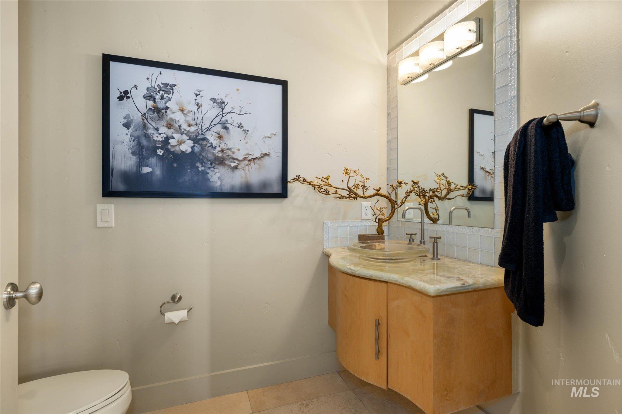 1400 North Razza Way Eagle, ID 83616 - Photo 18 of 50 Bathroom with vanity, tasteful backsplash, and light tile patterned flooring