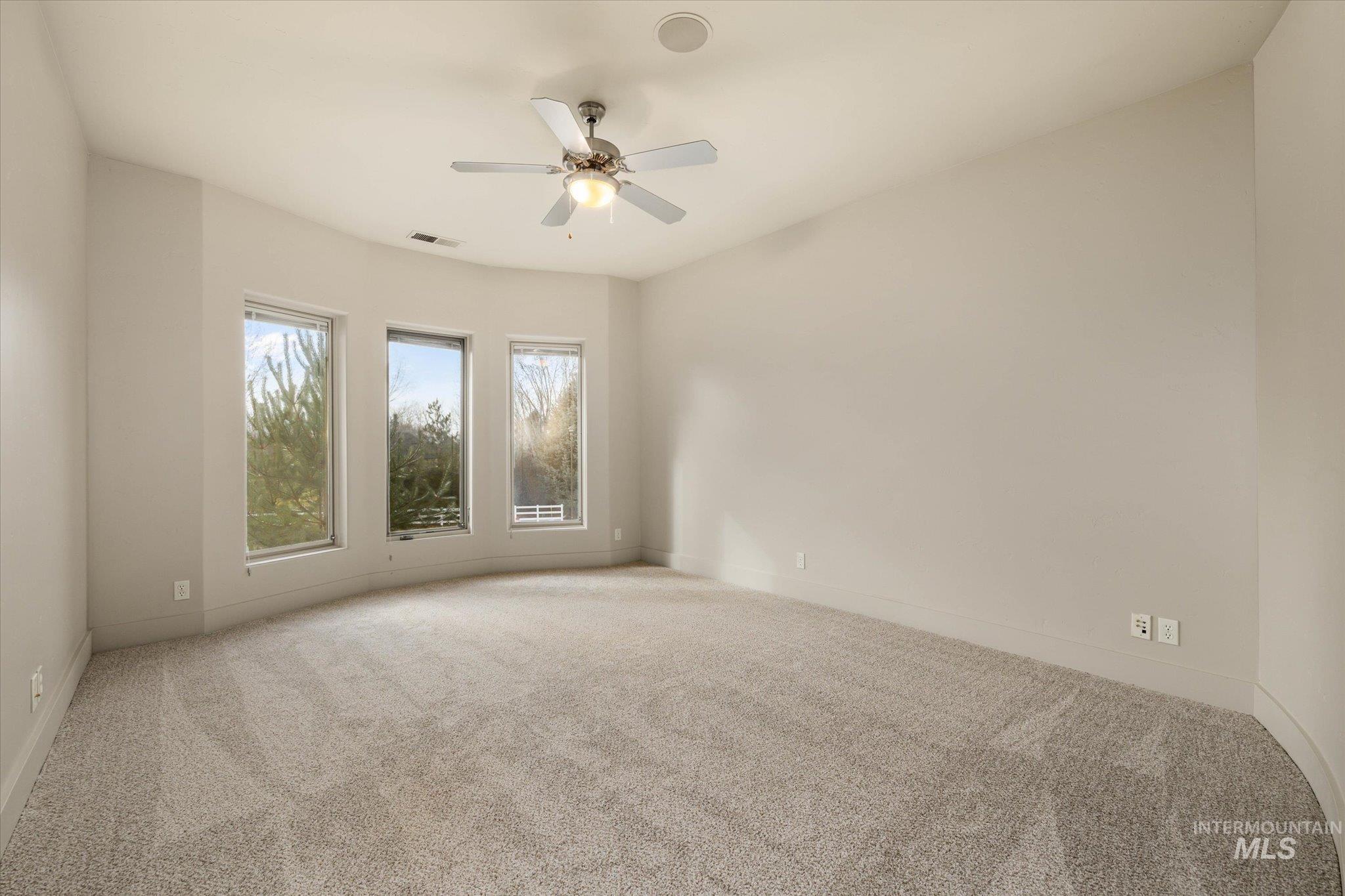 1400 North Razza Way Eagle, ID 83616 - Photo 28 of 50 Carpeted empty room featuring a ceiling fan and baseboards