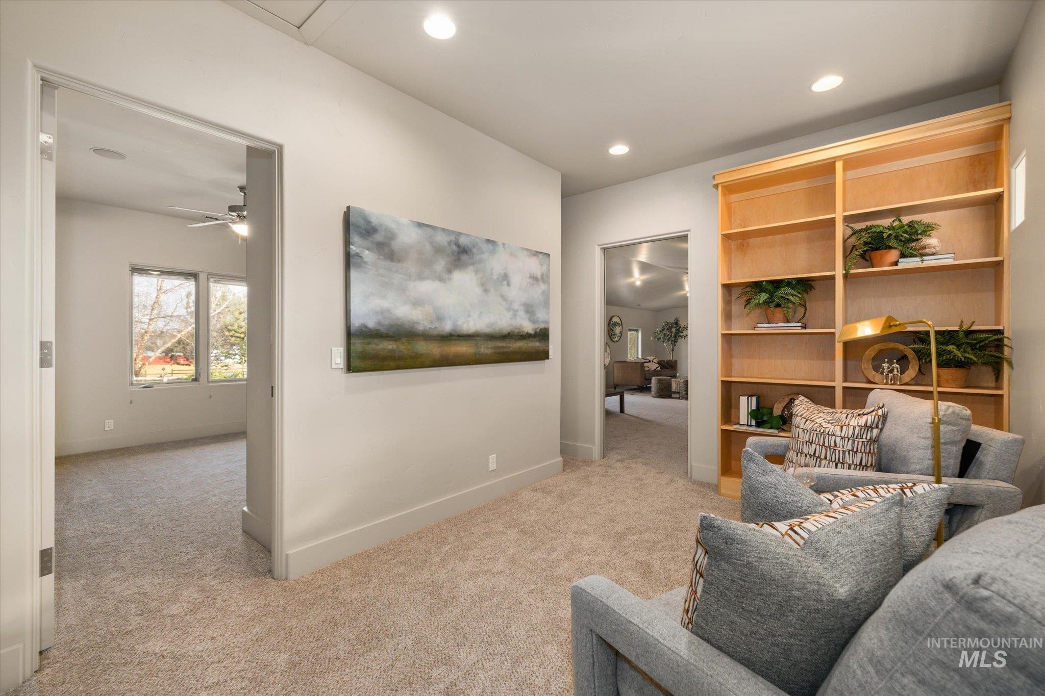1400 North Razza Way Eagle, ID 83616 - Photo 34 of 50 Living area with light colored carpet, recessed lighting, built in features, and a ceiling fan