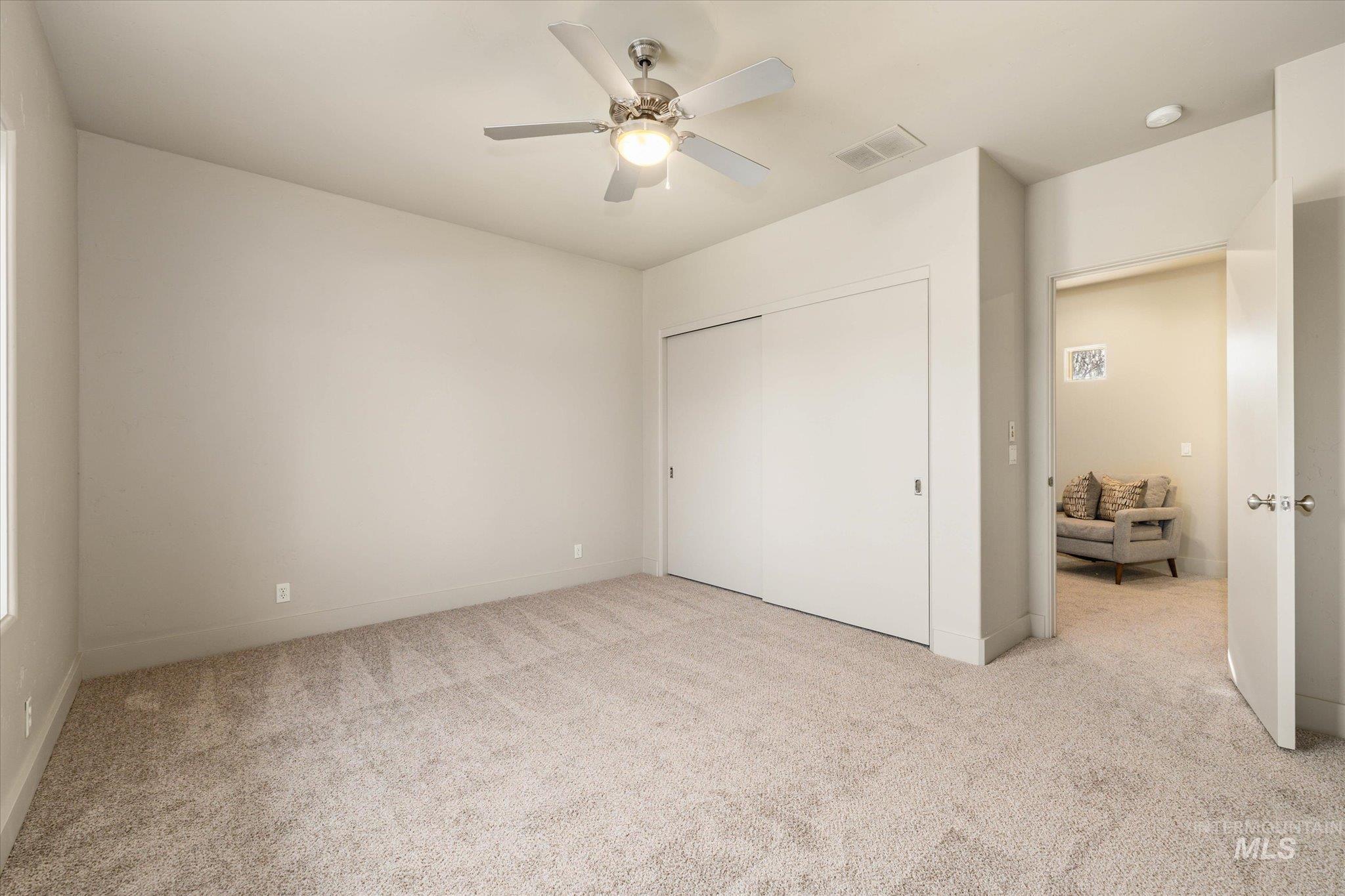 1400 North Razza Way Eagle, ID 83616 - Photo 36 of 50 Unfurnished bedroom featuring light colored carpet, a closet, and ceiling fan