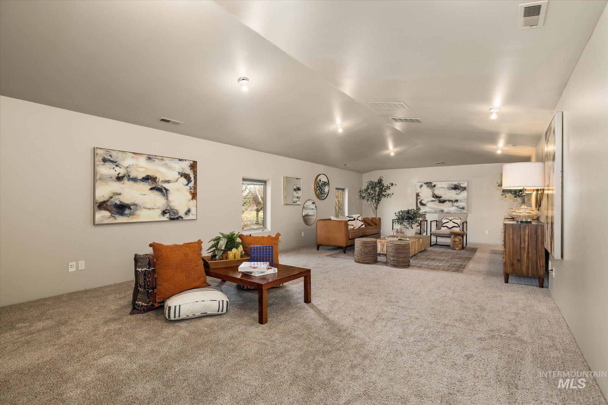 1400 North Razza Way Eagle, ID 83616 - Photo 37 of 50 Living room with light colored carpet and lofted ceiling