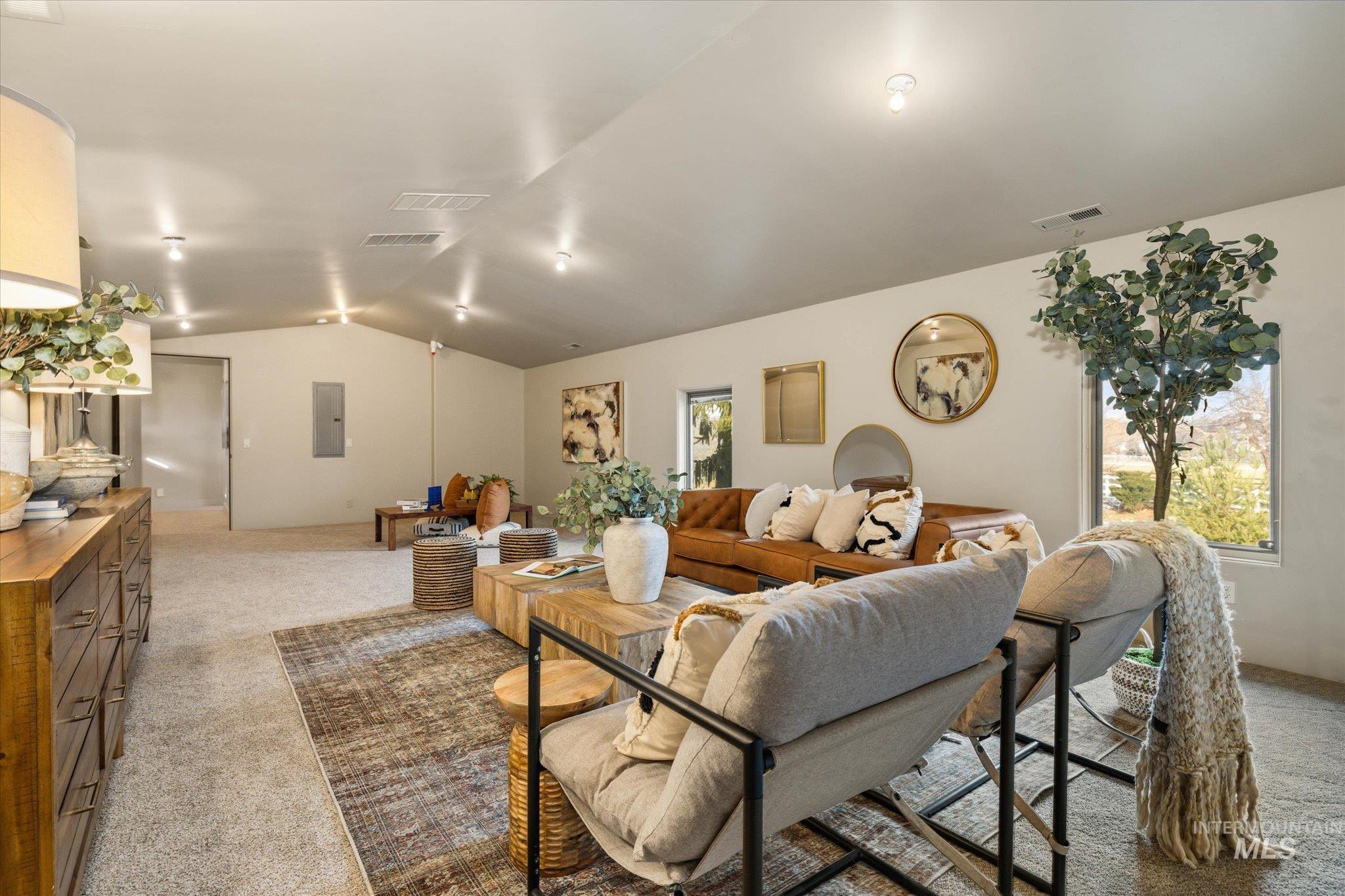 1400 North Razza Way Eagle, ID 83616 - Photo 38 of 50 Living area with light carpet, electric panel, and plenty of natural light