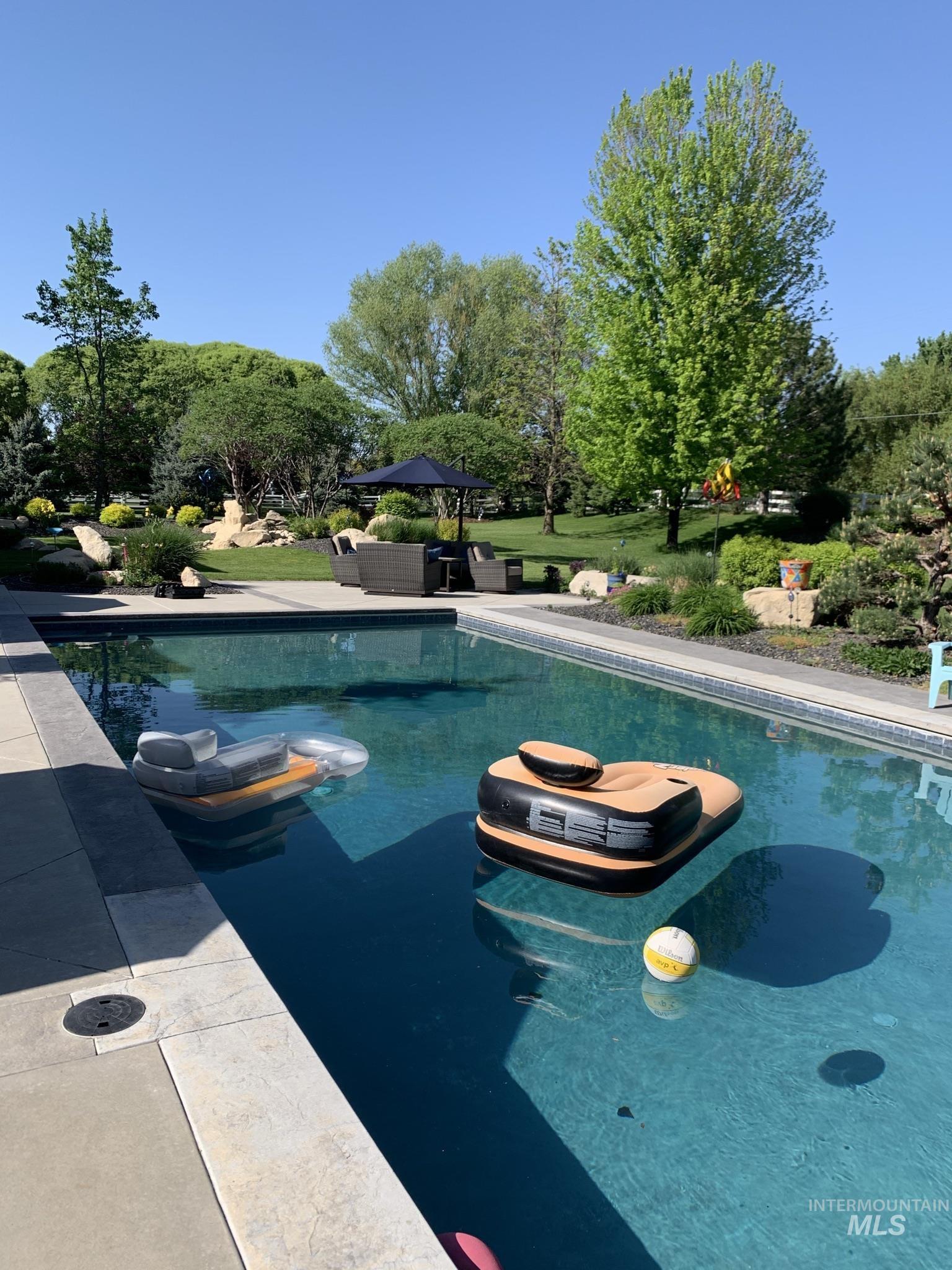 1400 North Razza Way Eagle, ID 83616 - Photo 6 of 50 Outdoor pool with a patio and outdoor lounge area