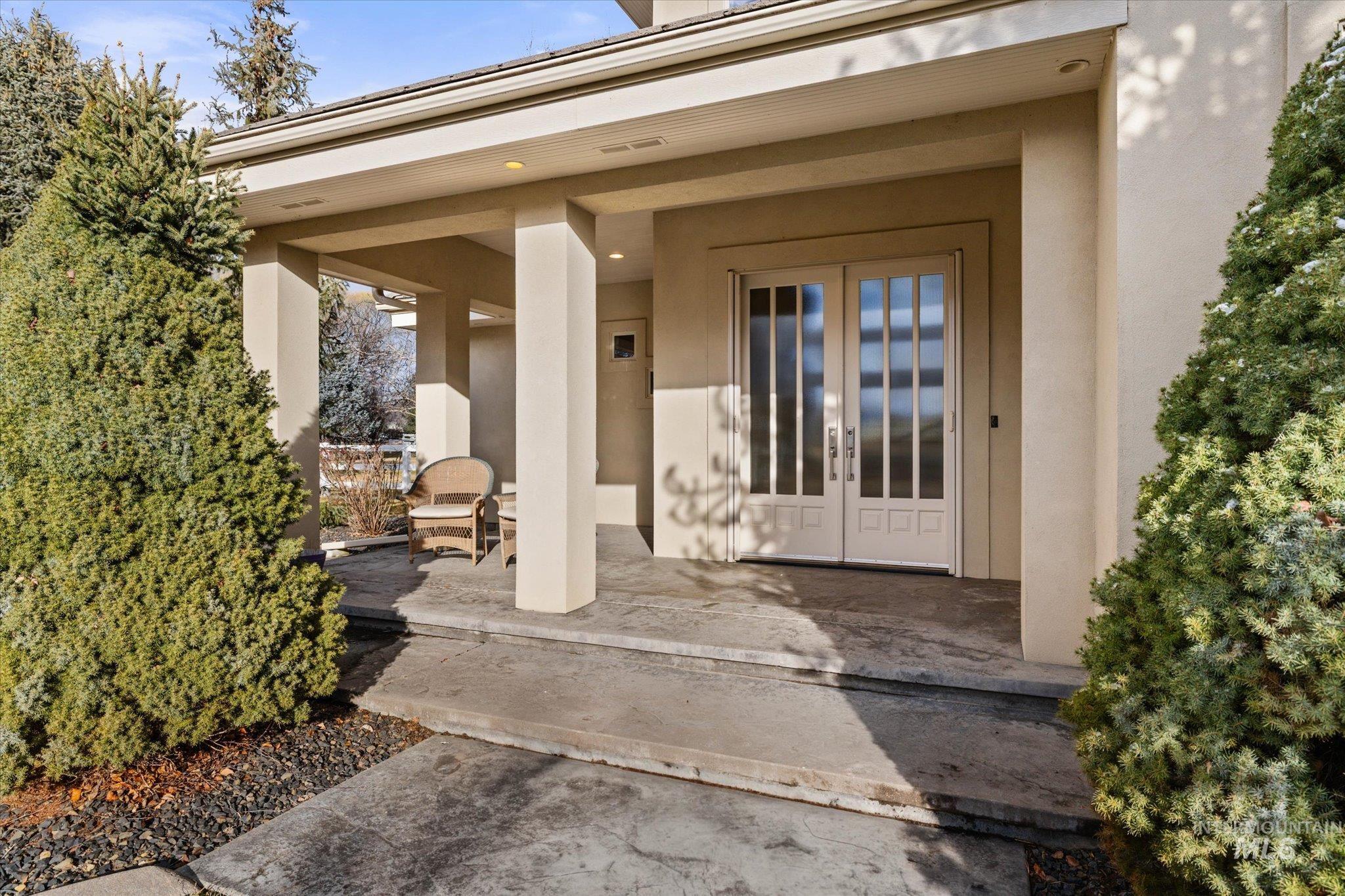 1400 North Razza Way Eagle, ID 83616 - Photo 9 of 50 Doorway to property with french doors and stucco siding