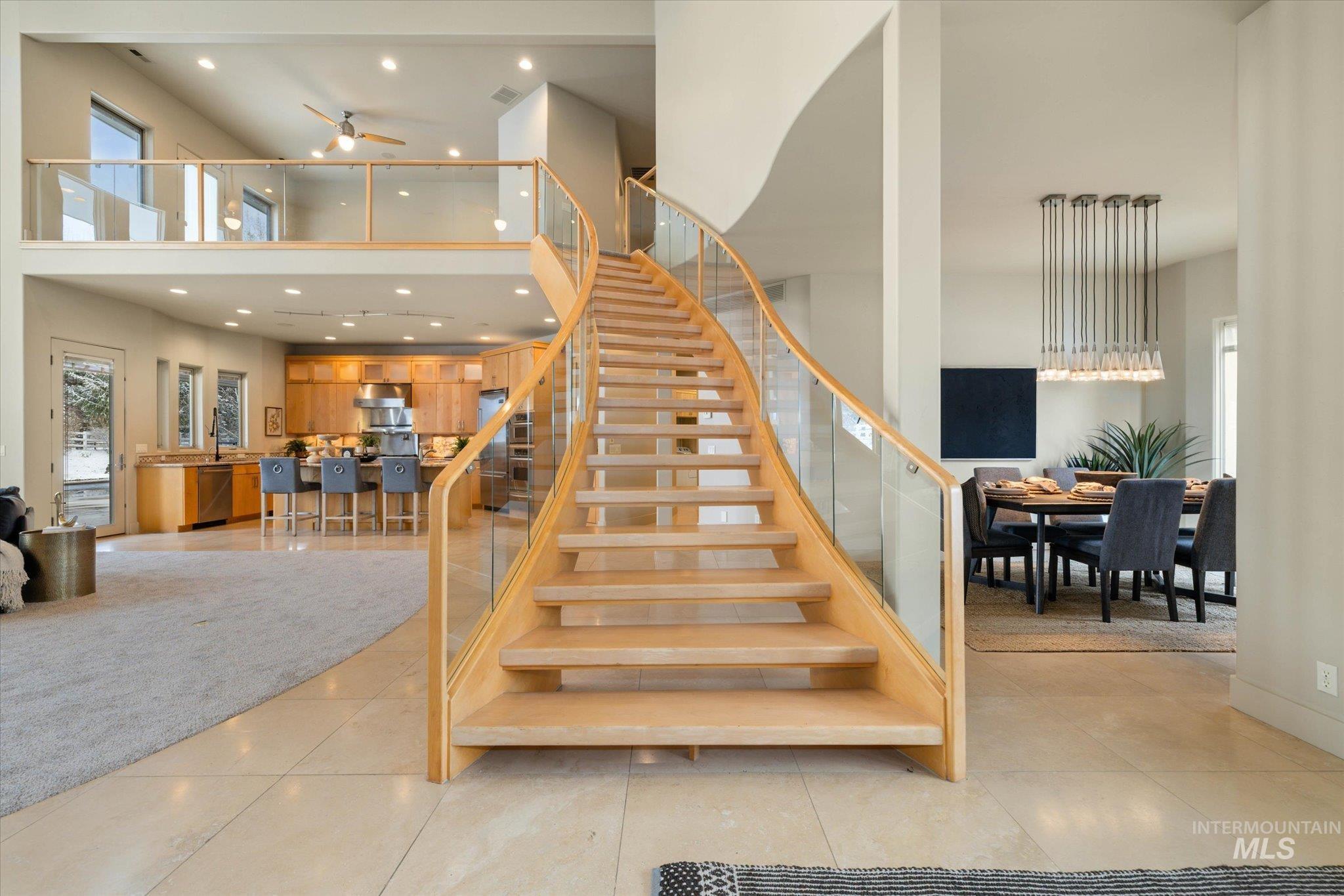 1400 North Razza Way Eagle, ID 83616 - Photo 10 of 50 Staircase with recessed lighting, a ceiling fan, a high ceiling, and tile patterned flooring