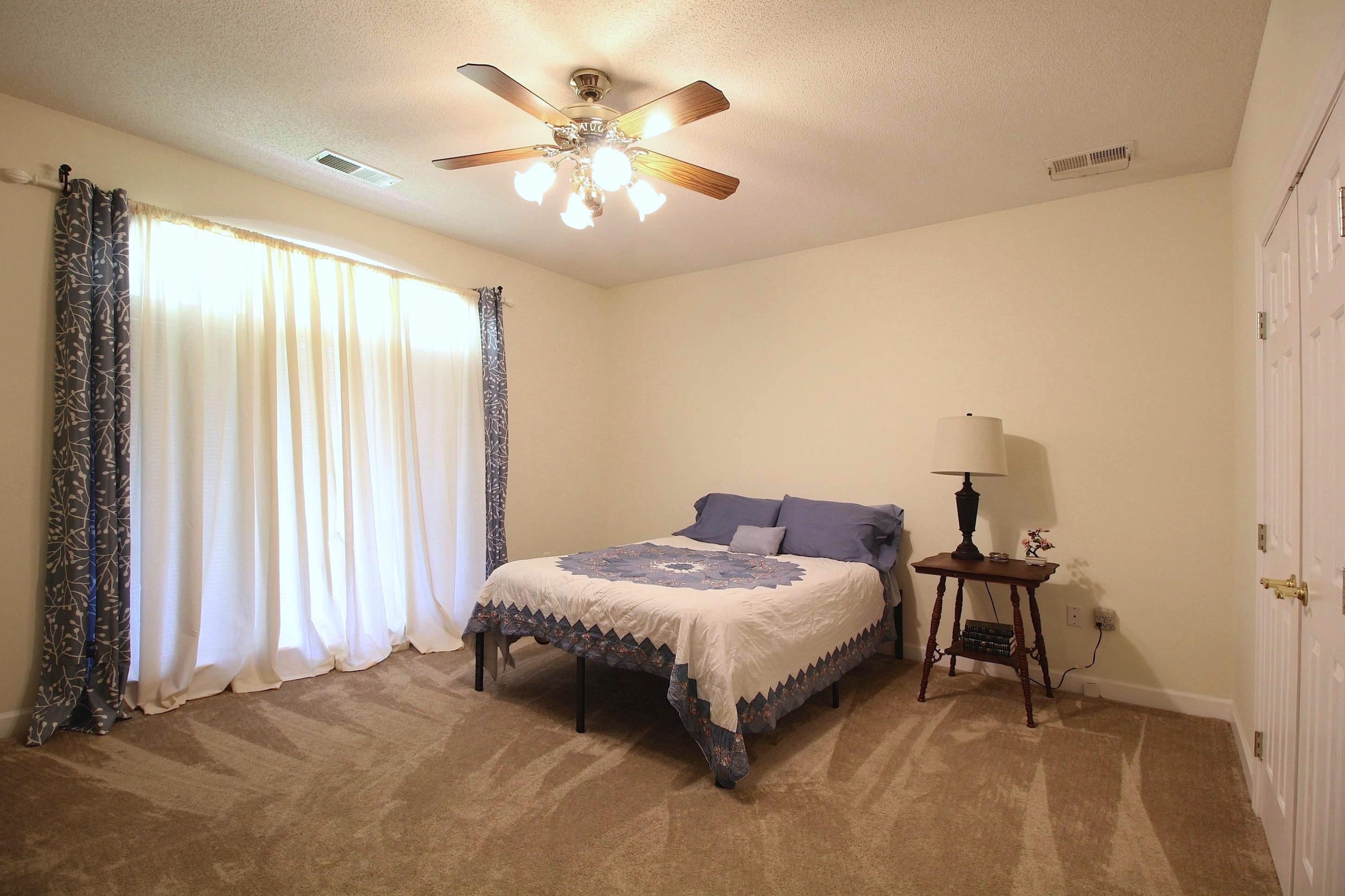 2550 North Reid Hooker Road Eads, TN 38028 - Photo 21 of 32 a bedroom with a bed and a chandelier