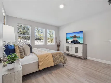 a bedroom with a bed and a couch