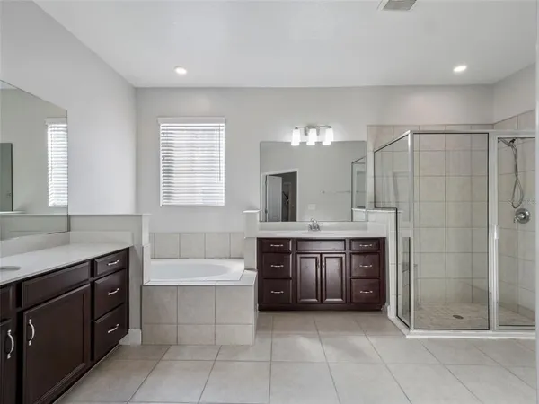 a spacious bathroom with a granite countertop toilet sink and mirror
