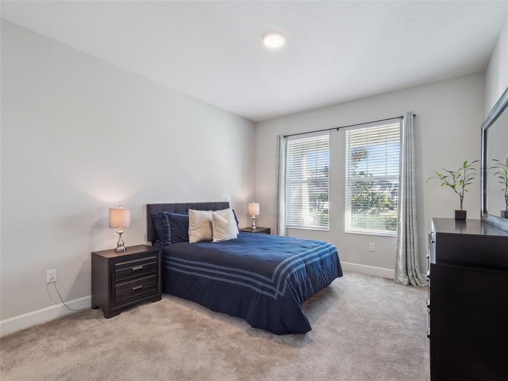 14345 Wabasso Loop Winter Garden, FL 34787 - Photo 15 of 31 a bedroom with a bed and a large window