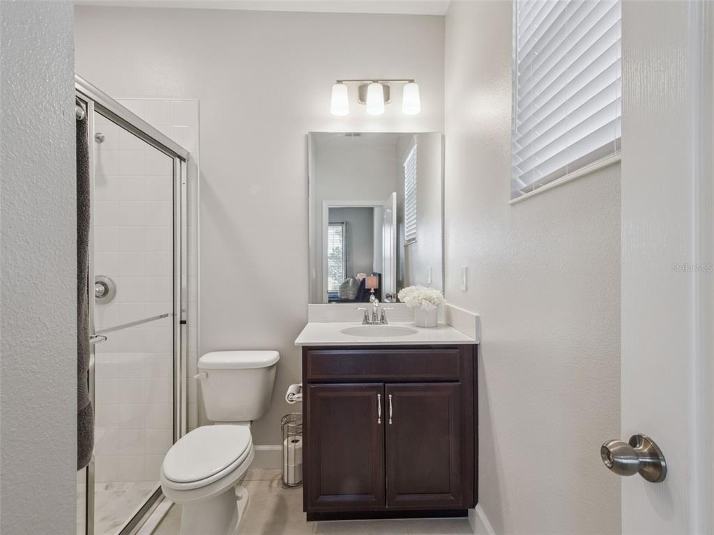 14345 Wabasso Loop Winter Garden, FL 34787 - Photo 16 of 31 a bathroom with a toilet sink vanity and mirror