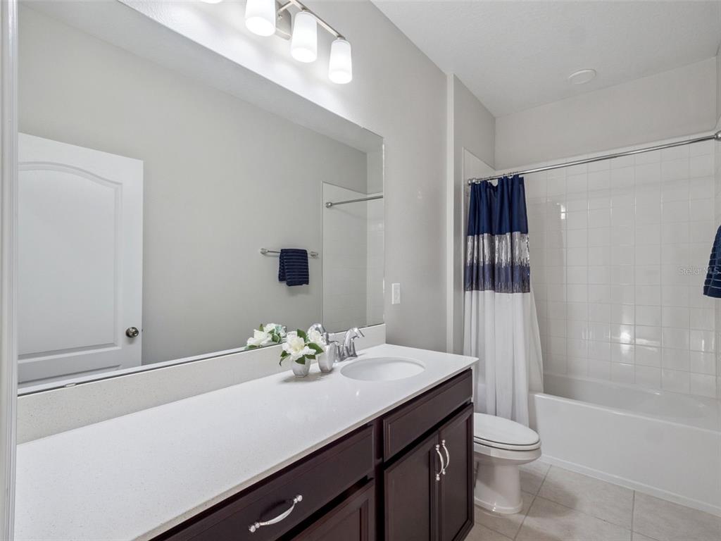 14345 Wabasso Loop Winter Garden, FL 34787 - Photo 18 of 31 a bathroom with a sink a toilet and shower