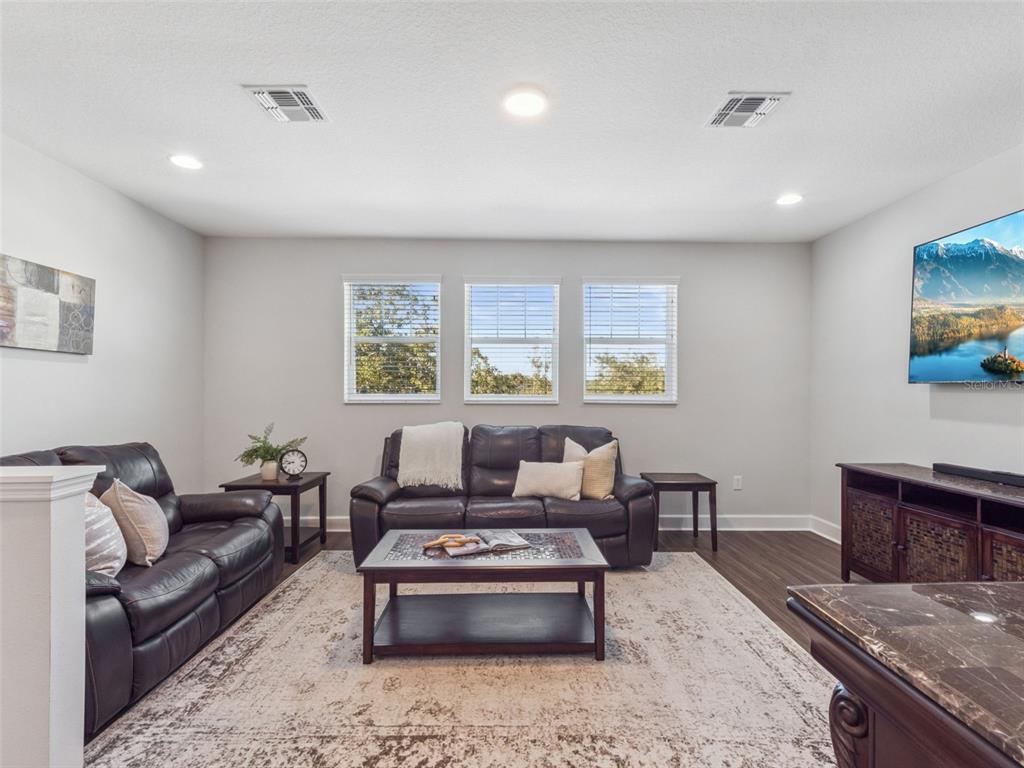 14345 Wabasso Loop Winter Garden, FL 34787 - Photo 21 of 31 a living room with furniture and a flat screen tv