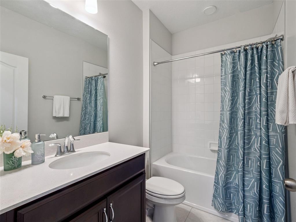 14345 Wabasso Loop Winter Garden, FL 34787 - Photo 23 of 31 a bathroom with a sink a toilet a mirror a bathtub and shower