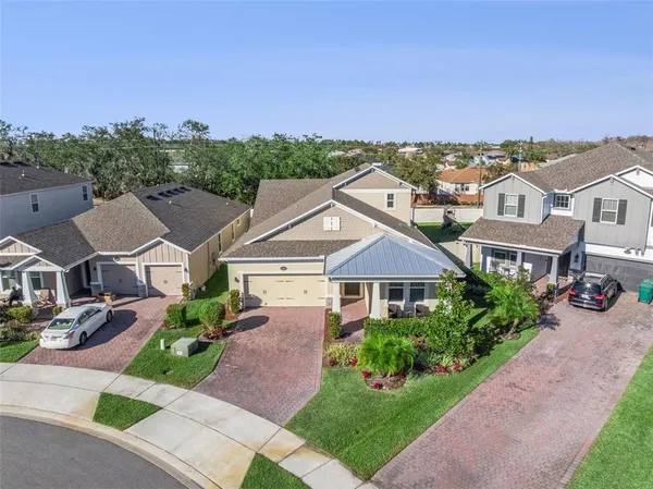 an aerial view of multiple houses with a yard
