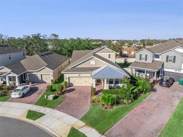 an aerial view of multiple houses with a yard