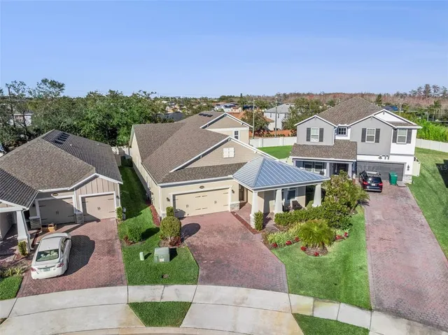 a front view of a house with a garden and plants