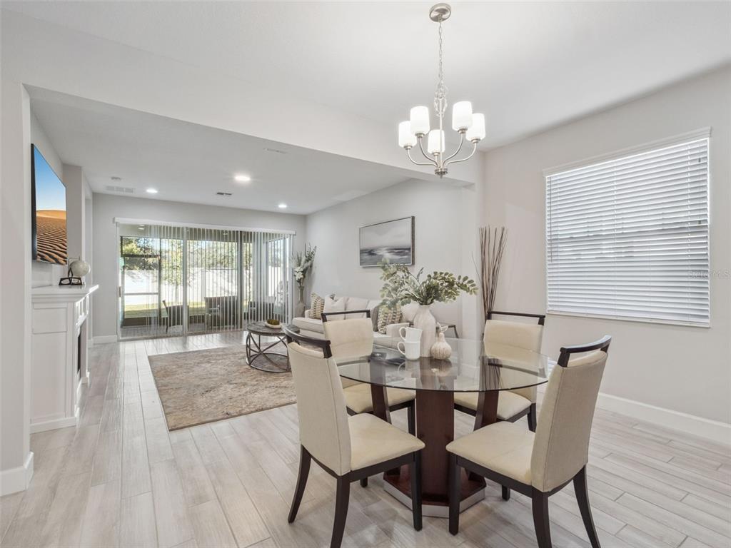 14345 Wabasso Loop Winter Garden, FL 34787 - Photo 6 of 31 a view of a dining room with furniture a chandelier and wooden floor