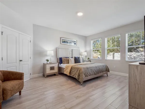 a bedroom with a bed table and window