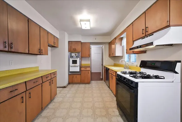a bedroom with furniture and a large window