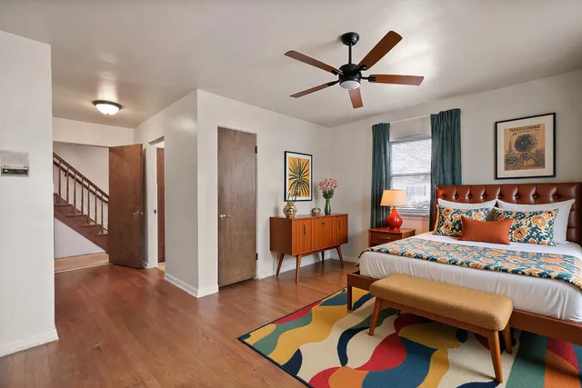 a bathroom with a toilet a sink a mirror and a window