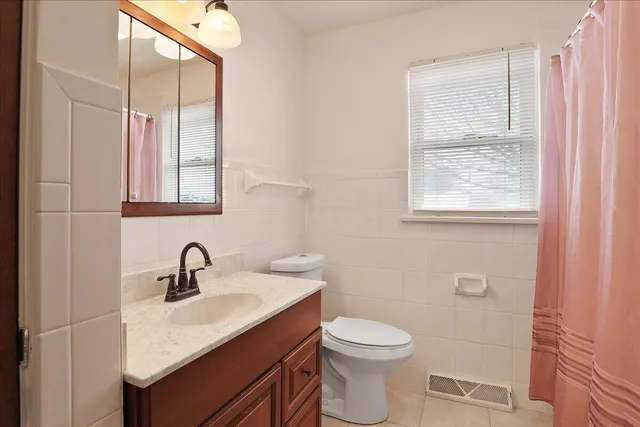 a bedroom with a bed couch and a window