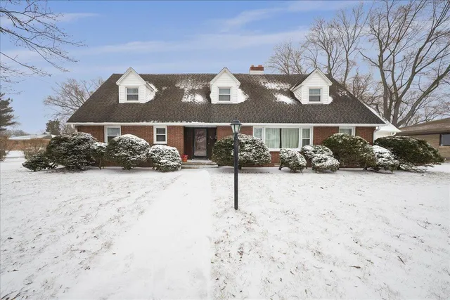 a view of a house with a snow on the road