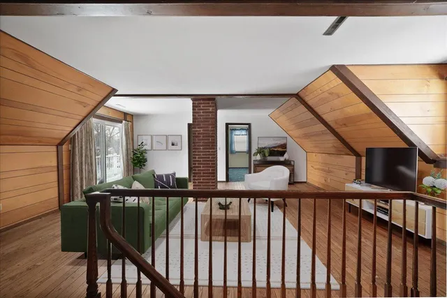 a view of staircase with wooden floor and white walls