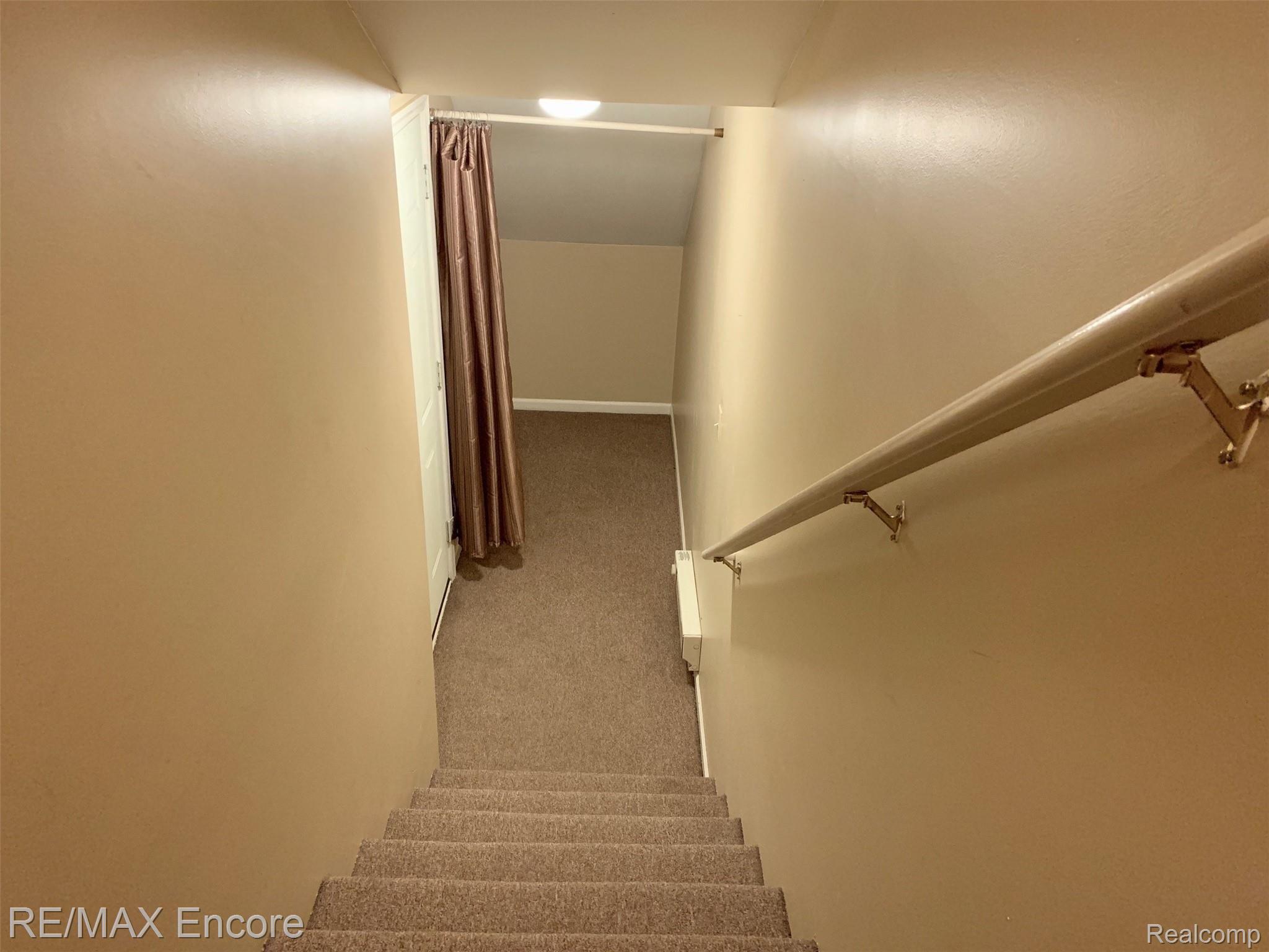 3522 Tremonte Circle Rochester, MI 48306 - Photo 23 of 31 Staircase from garage to condo. Convenient storage room off garage.