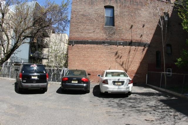 409 Adams Street, Unit 8 Hoboken, NJ 07030 - Photo 16 of 17 a car parked in front of a brick house