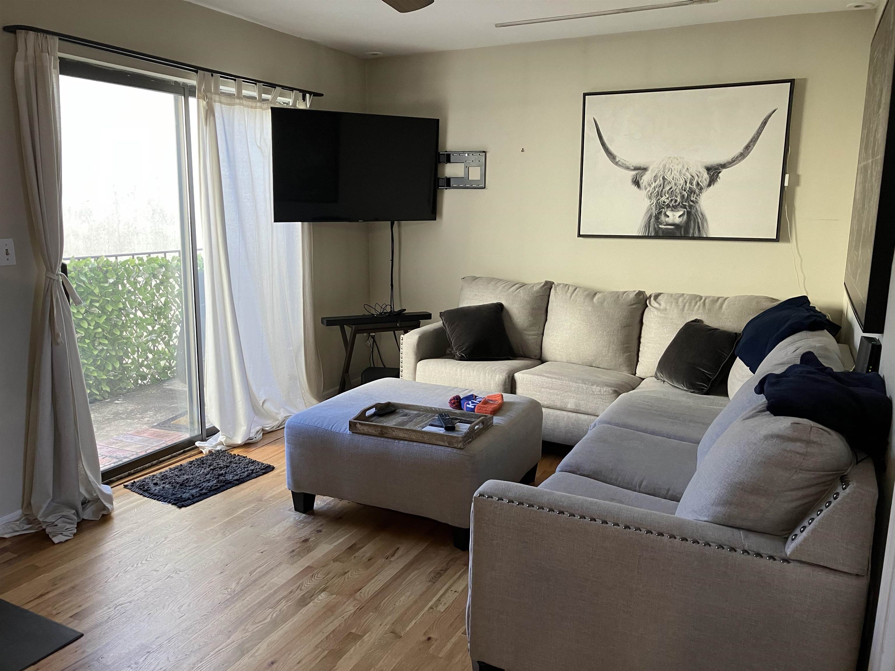 409 Adams Street, Unit 8 Hoboken, NJ 07030 - Photo 3 of 17 a living room with furniture and a flat screen tv