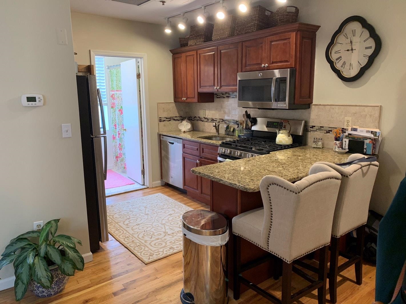 409 Adams Street, Unit 8 Hoboken, NJ 07030 - Photo 9 of 17 a view of a kitchen with granite countertop a table and chairs