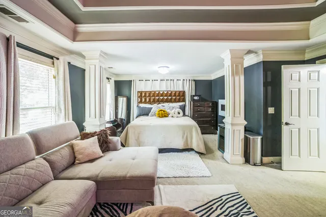 a bedroom with a bed couch and a window