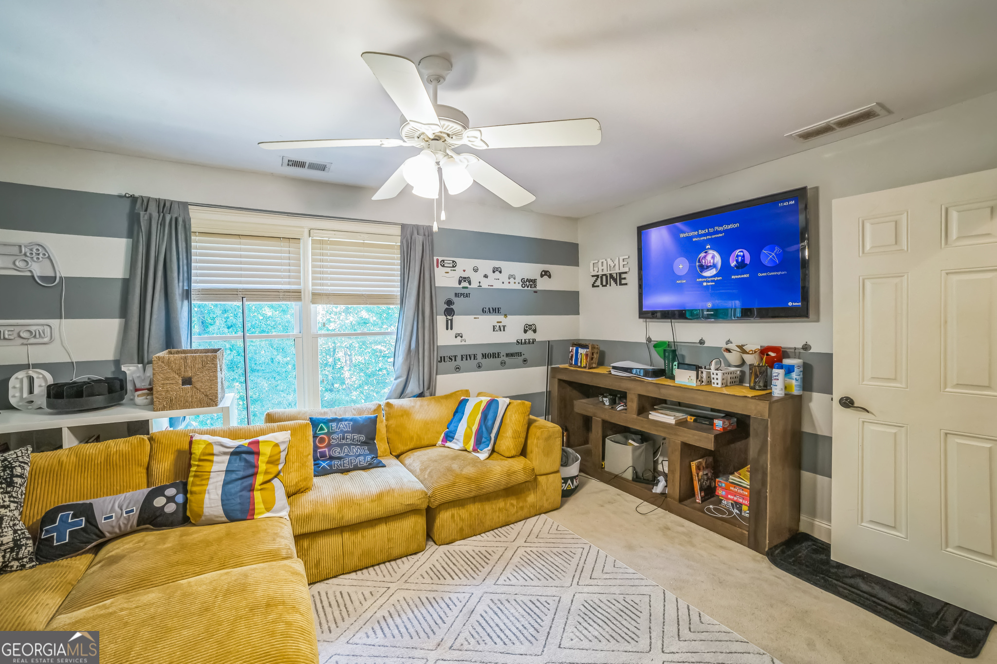 8260 Equinox Lane Fairburn, GA 30213 - Photo 17 of 39 a living room with furniture and a flat screen tv