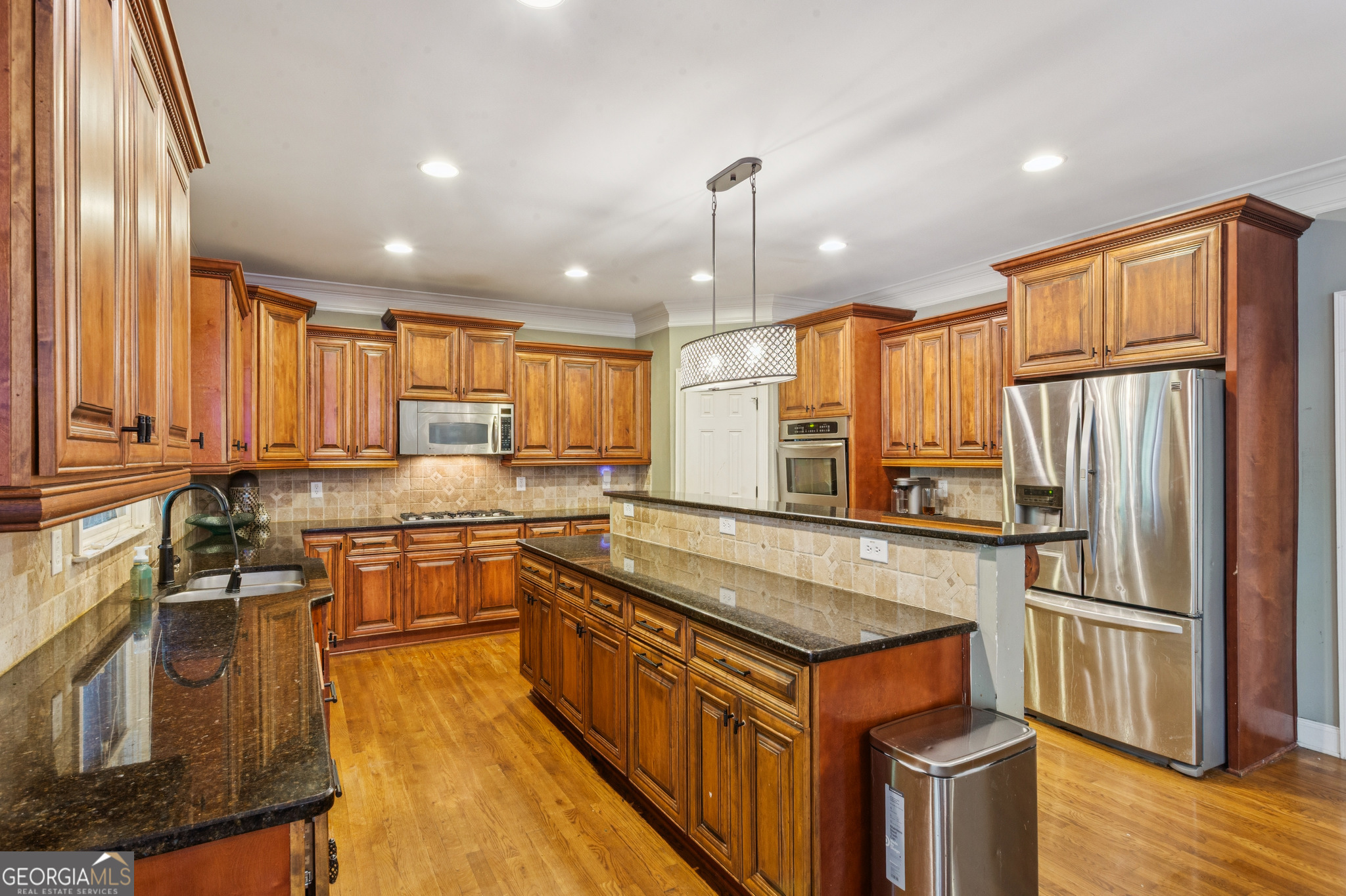 8260 Equinox Lane Fairburn, GA 30213 - Photo 24 of 39 a kitchen with stainless steel appliances granite countertop a stove a sink a refrigerator and island