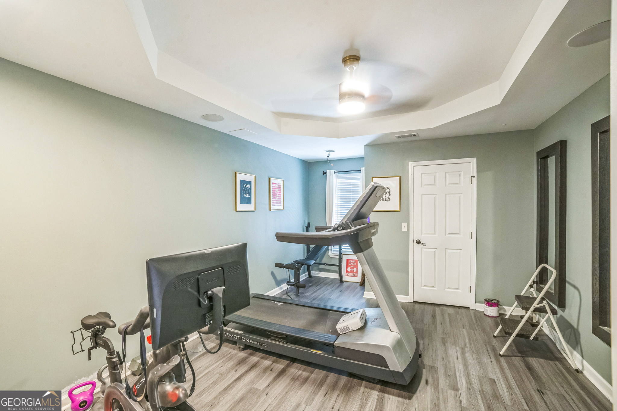8260 Equinox Lane Fairburn, GA 30213 - Photo 39 of 39 a living room with furniture a wooden floor and a chandelier