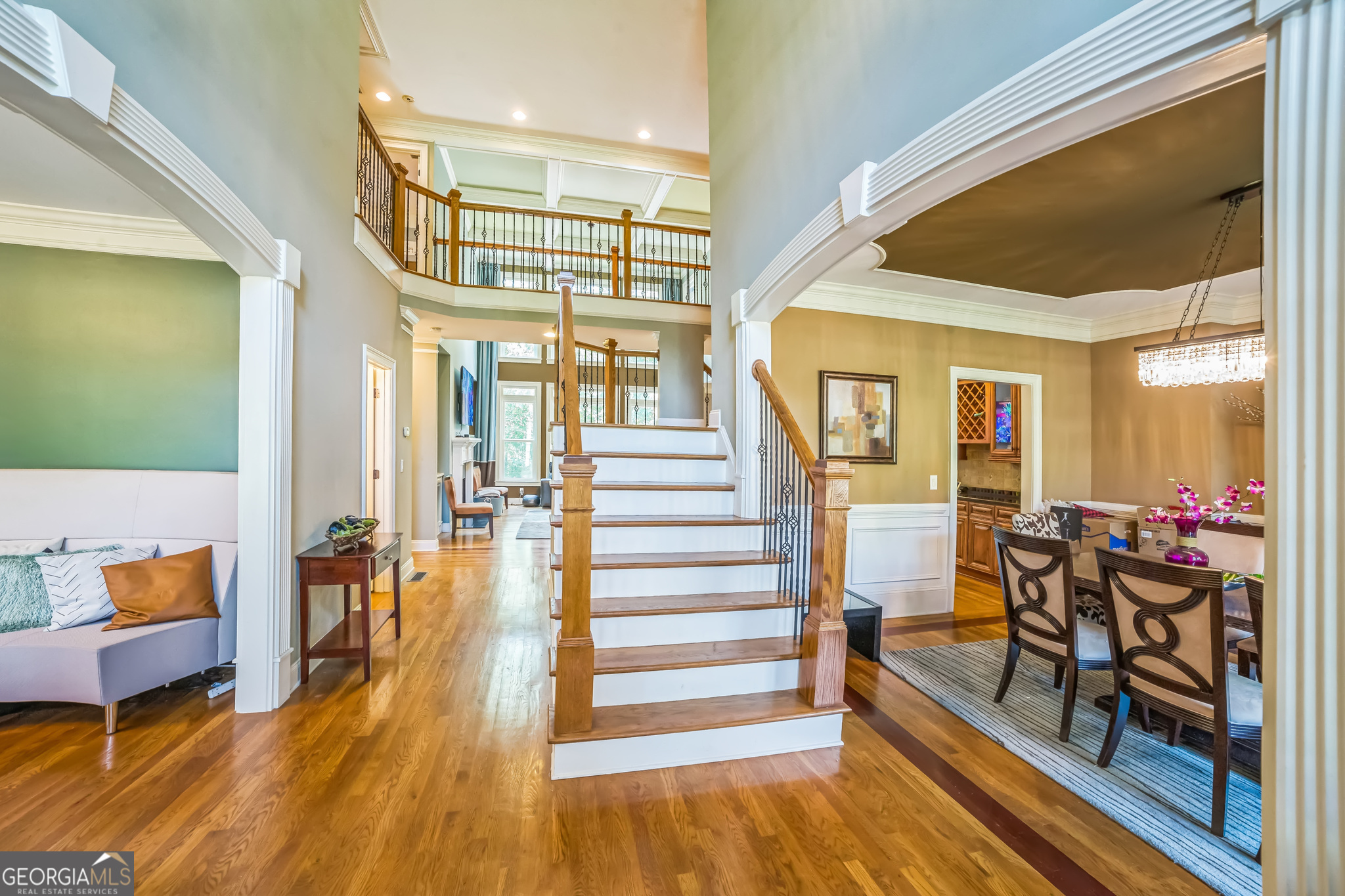 8260 Equinox Lane Fairburn, GA 30213 - Photo 7 of 39 a view of entryway dining room and hall with wooden floor