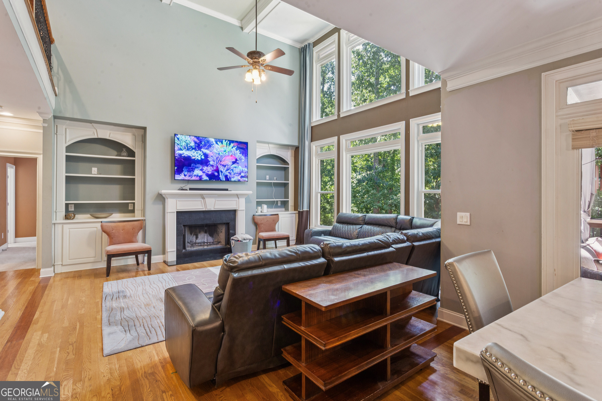 8260 Equinox Lane Fairburn, GA 30213 - Photo 10 of 39 a living room with furniture a fireplace and a floor to ceiling window