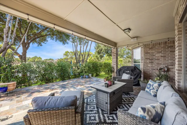 a backyard of a house with yard and outdoor seating