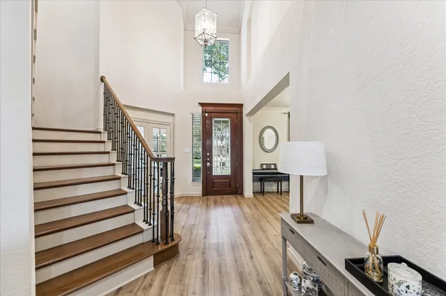 a view of entryway with wooden floor and a front door